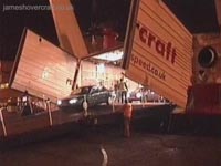 Rear cargo doors opened, with ramp attached for vehicles